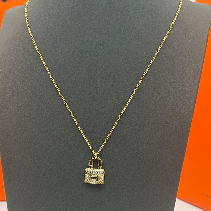 Name: Hermès Amulettes Constance Pendant / Necklace  
 Color: Gold / rose gold/silver