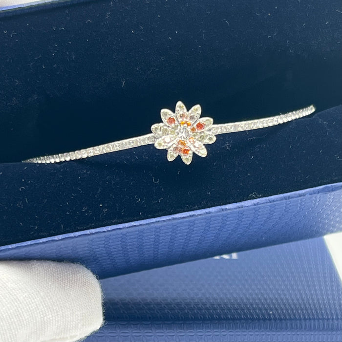Swarovski Sunshine / Eternal Flower / Daisy Motif Bangle  
 Color: Silver, white, and warm tones (featuring clear and orange/peach crystals