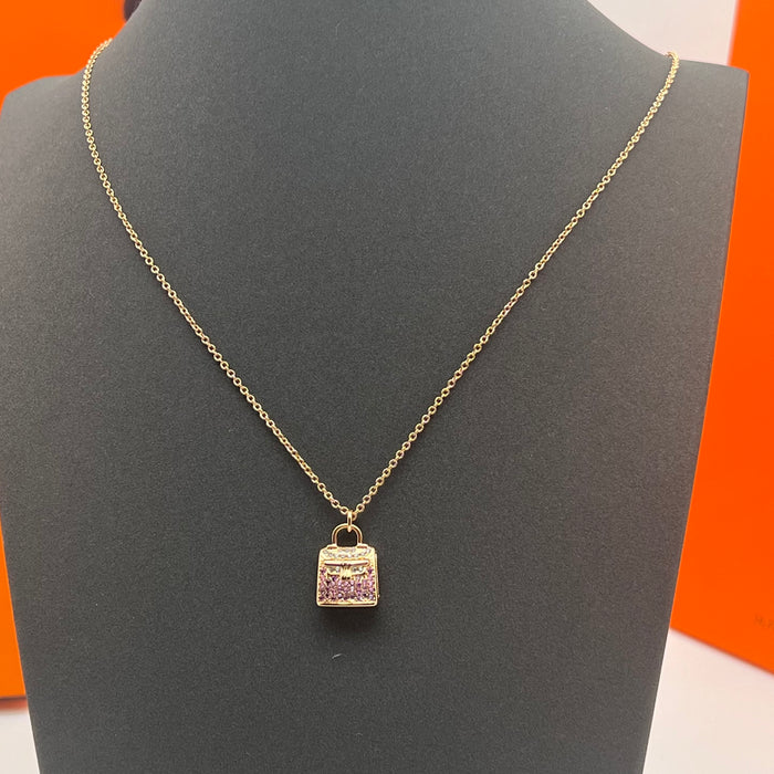 Hermès Amulettes Kelly Pendant Necklace  
 Color: Gold with Purple crystal/rose gold with purple crystal