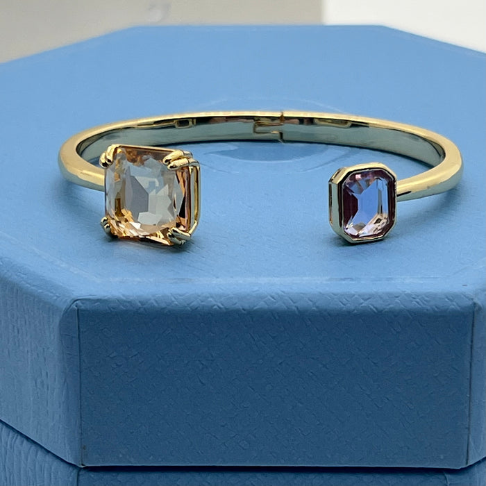 Swarovski Millenia Open Bangle / Dual Cut Crystal Cuff  
 Color: Gold-tone with light champagne/peach and pale lavender/lilac crystals