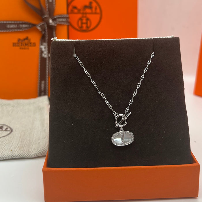 Hermès Finesse Pendant Necklace  
 Color: Silver / Rose Gold tone with White Mother-of-Pearl & Clear Pave Accents