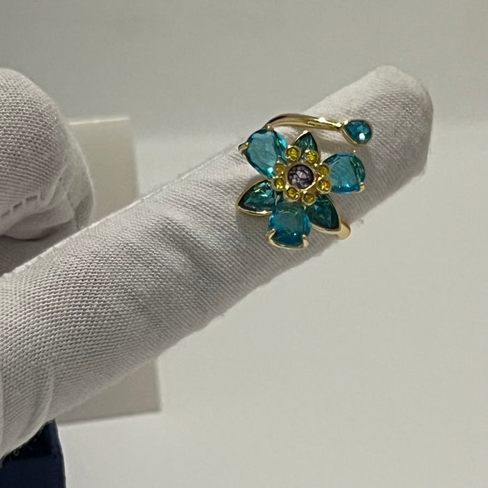 Swarovski Idyllia Blue Flower Ring 
 Color: Vibrant turquoise blue with a central purple crystal and yellow accent crystals (Left) / Shades of green, olive, and yellow with small pink crystal accents (Right