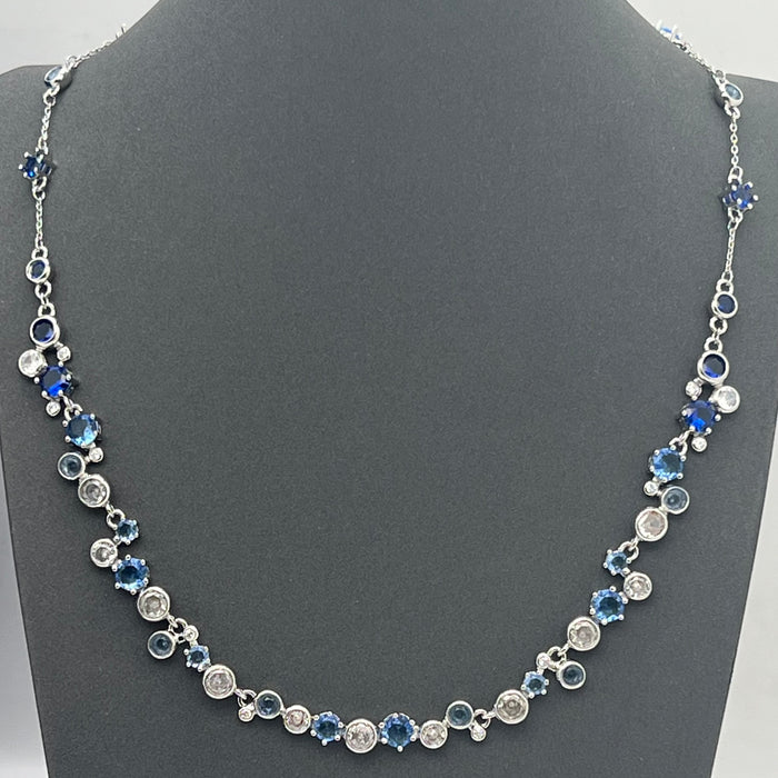 Swarovski Constella / Millenia Blue Crystal Bezel-Set Necklace  
 Color: Blue and silver-tone (Featuring alternating shades of deep and light blue crystals combined with clear round stones)