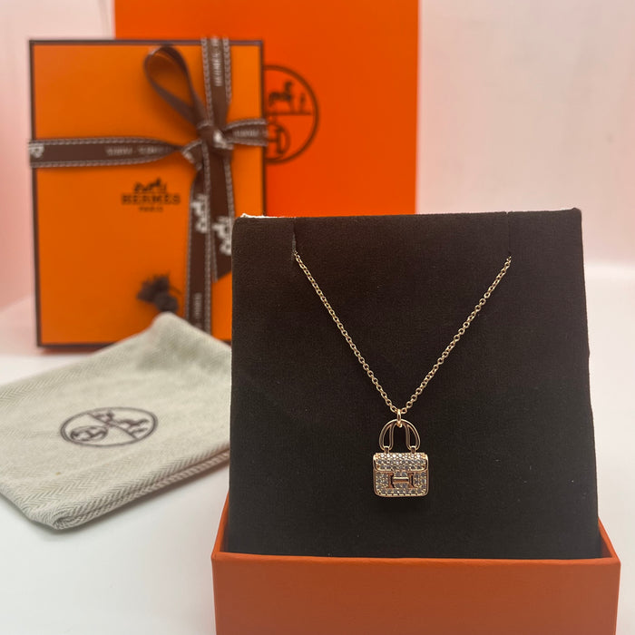 Name: Hermès Amulettes Constance Pendant / Necklace  
 Color: Gold / rose gold/silver