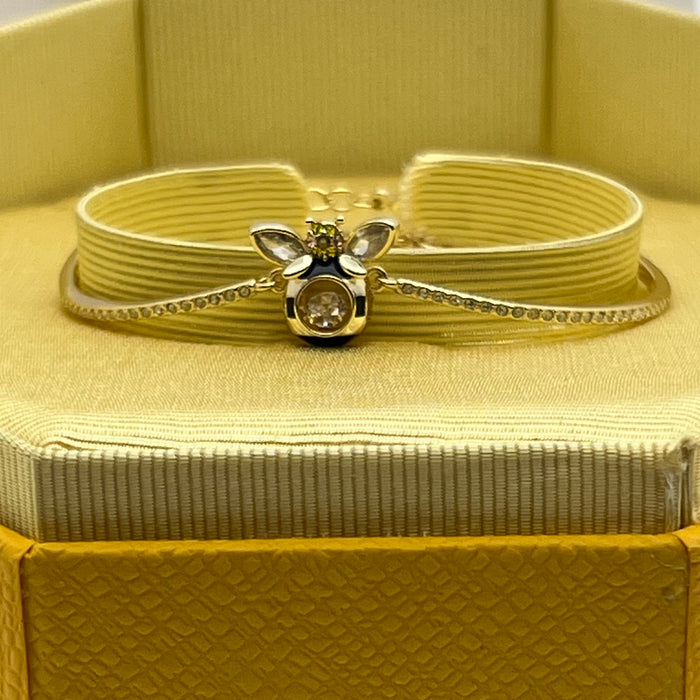Swarovski Idyllia / Sparkling Dance Bee Bangle  
 Color: Gold-tone, black, and clear/yellow (featuring black enamel stripes and crystal stones)