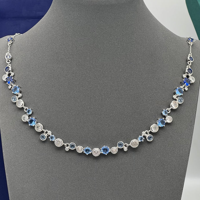 Swarovski Constella / Millenia Blue Crystal Bezel-Set Necklace  
 Color: Blue and silver-tone (Featuring alternating shades of deep and light blue crystals combined with clear round stones)
