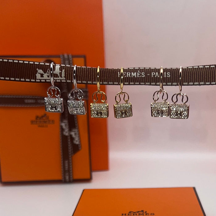 Hermès Amulettes Constance Earrings / Mini Constance Drop Earrings  
 Color: Silver, Gold, and Rose Gold finishes