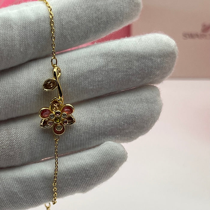Swarovski Idyllia Single Flower & Stem Chain Bracelet  
 Color: Gold-tone with multicolored crystals (featuring pink, brown, olive green, and clear stones
