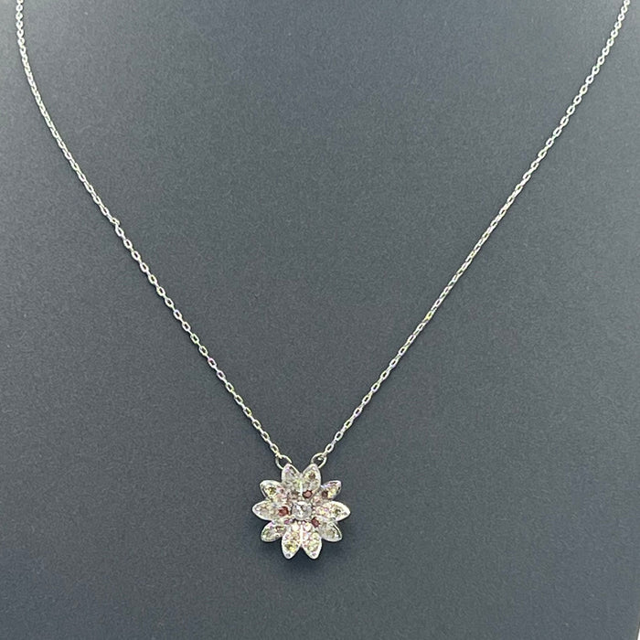 Swarovski Idyllia Daisy / Sunflower Pendant Necklace  
 Color: Silver-tone with pale yellow/champagne pavé petals, a central clear crystal, and contrasting amber-orange crystal accents