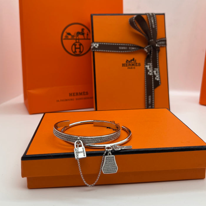 Hermès  double Kelly Clochette / Lock  Bangle Bracelet  
 Color: Silver / with clear pavé crystals/diamonds