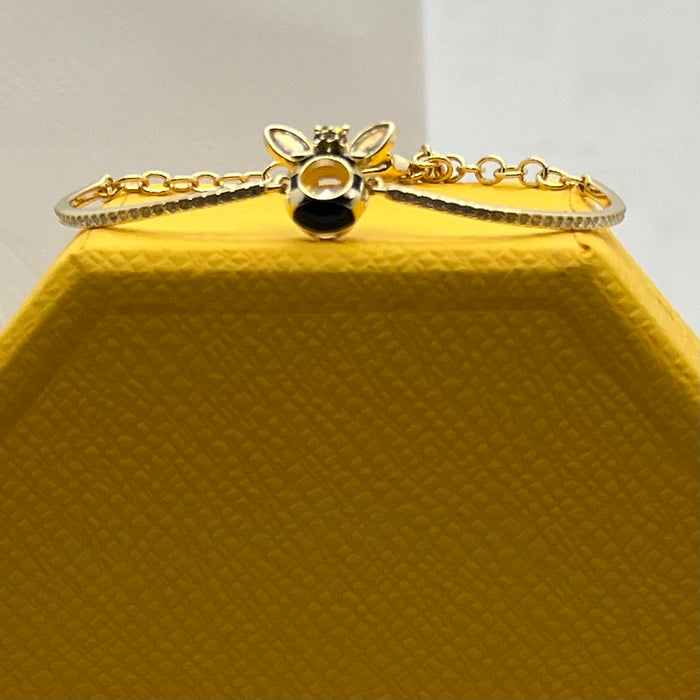 Swarovski Idyllia / Sparkling Dance Bee Bangle  
 Color: Gold-tone, black, and clear/yellow (featuring black enamel stripes and crystal stones)