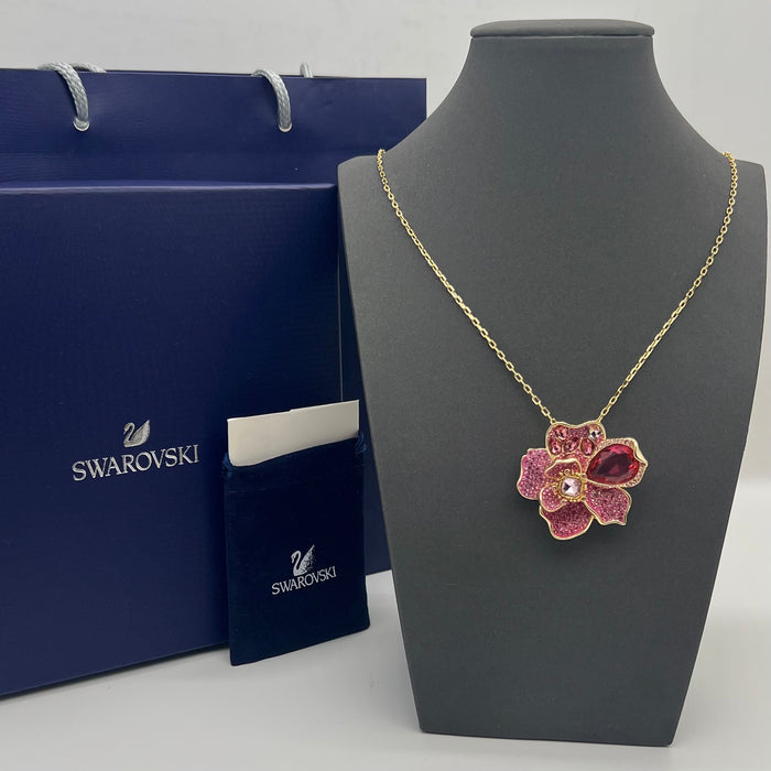 Swarovski Idyllia Pink Crystal Flower Pendant / Necklace  
 Color: Gold-tone chain with layered pink, magenta, and clear crystal pavé petals accented by a prominent deep-pink pear-cut crystal