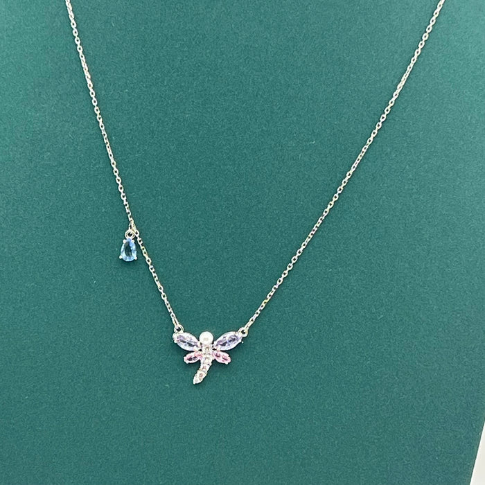 Mixed Cuts Dragonfly Y-Necklace / Pendant (Ariana Grande x Swarovski Collection)
 Color: Multicolored (Silver chain with pastel pink, purple, and a distinct blue crystal accent drop)