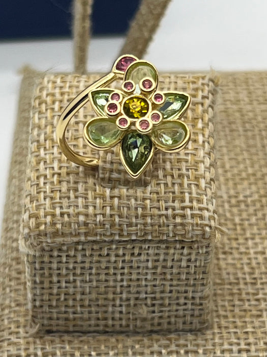 Swarovski Idyllia Blue Flower Ring 
 Color: Vibrant turquoise blue with a central purple crystal and yellow accent crystals (Left) / Shades of green, olive, and yellow with small pink crystal accents (Right