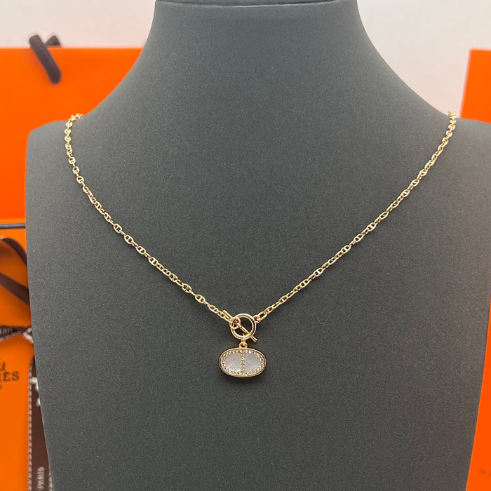 Hermès Finesse Pendant Necklace  
 Color: Silver / Rose Gold tone with White Mother-of-Pearl & Clear Pave Accents