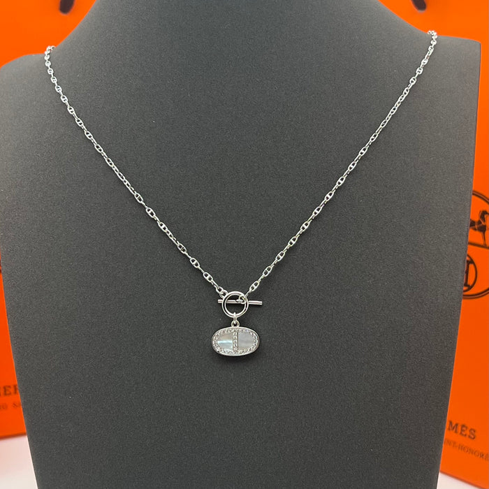 Hermès Finesse Pendant Necklace  
 Color: Silver / Rose Gold tone with White Mother-of-Pearl & Clear Pave Accents