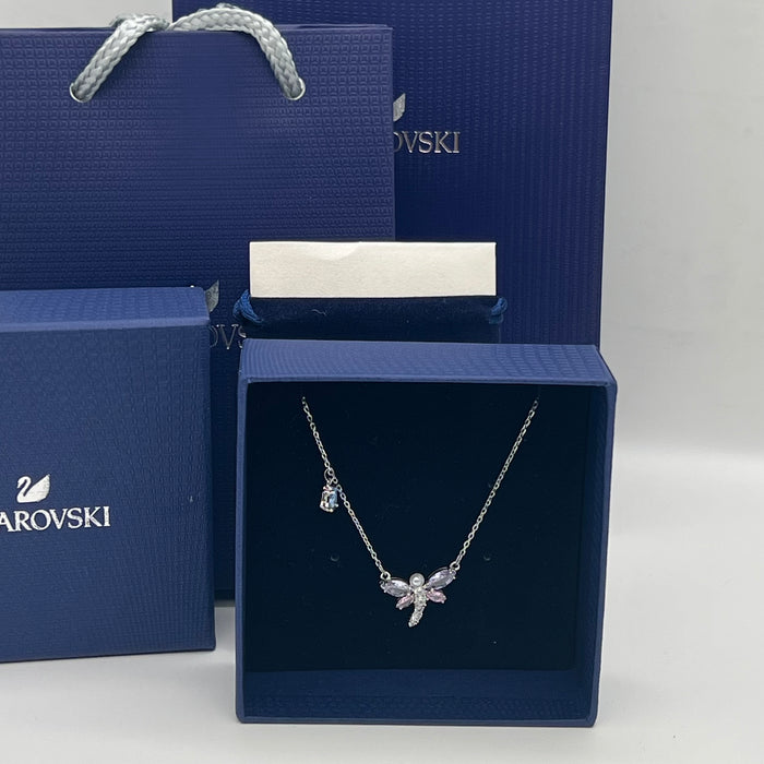 Mixed Cuts Dragonfly Y-Necklace / Pendant (Ariana Grande x Swarovski Collection)
 Color: Multicolored (Silver chain with pastel pink, purple, and a distinct blue crystal accent drop)