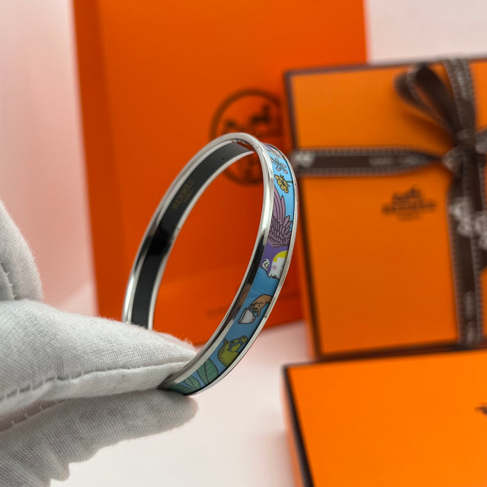 Hermès Enamel Printed Narrow Bangle / Bracelet  
 Color: Multicolor printed motif (light green/mint,/light blue/(powder blue, lilac/purple, soft yellow, and grey) with silver-tone rim and black inner lining