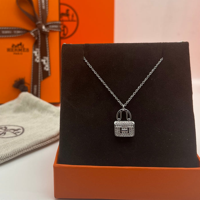 Name: Hermès Amulettes Constance Pendant / Necklace  
 Color: Gold / rose gold/silver