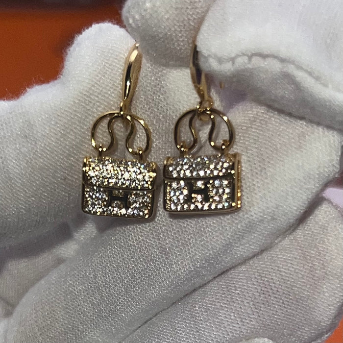 Hermès Amulettes Constance Earrings / Mini Constance Drop Earrings  
 Color: Silver, Gold, and Rose Gold finishes