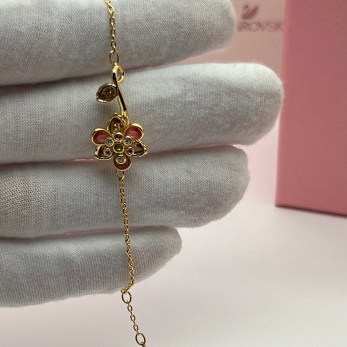 Swarovski Idyllia Single Flower & Stem Chain Bracelet  
 Color: Gold-tone with multicolored crystals (featuring pink, brown, olive green, and clear stones