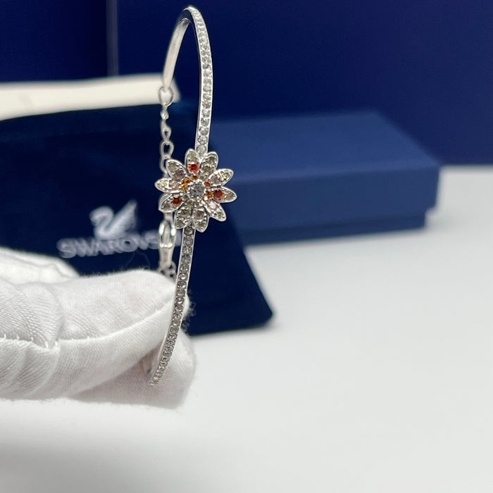 Swarovski Sunshine / Eternal Flower / Daisy Motif Bangle  
 Color: Silver, white, and warm tones (featuring clear and orange/peach crystals