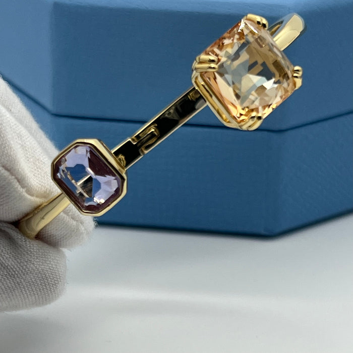 Swarovski Millenia Open Bangle / Dual Cut Crystal Cuff  
 Color: Gold-tone with light champagne/peach and pale lavender/lilac crystals
