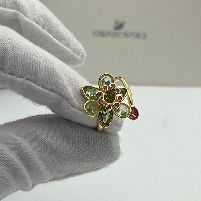 Swarovski Idyllia Blue Flower Ring 
 Color: Vibrant turquoise blue with a central purple crystal and yellow accent crystals (Left) / Shades of green, olive, and yellow with small pink crystal accents (Right