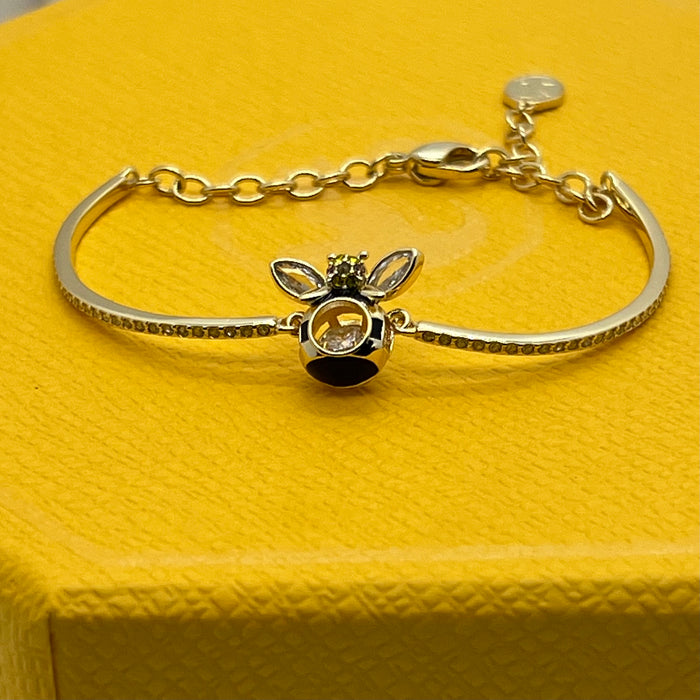 Swarovski Idyllia / Sparkling Dance Bee Bangle  
 Color: Gold-tone, black, and clear/yellow (featuring black enamel stripes and crystal stones)