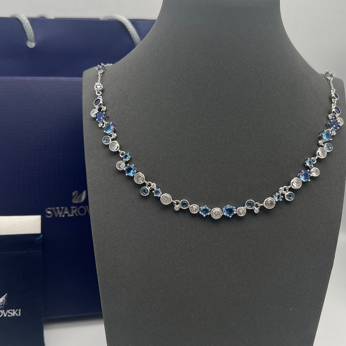 Swarovski Constella / Millenia Blue Crystal Bezel-Set Necklace  
 Color: Blue and silver-tone (Featuring alternating shades of deep and light blue crystals combined with clear round stones)