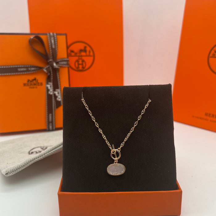 Hermès Finesse Pendant Necklace  
 Color: Silver / Rose Gold tone with White Mother-of-Pearl & Clear Pave Accents