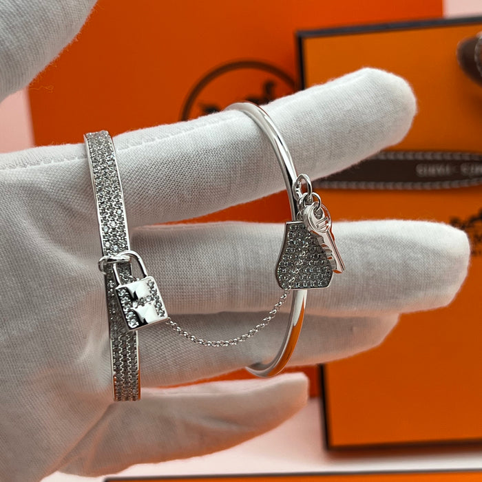 Hermès  double Kelly Clochette / Lock  Bangle Bracelet  
 Color: Silver / with clear pavé crystals/diamonds
