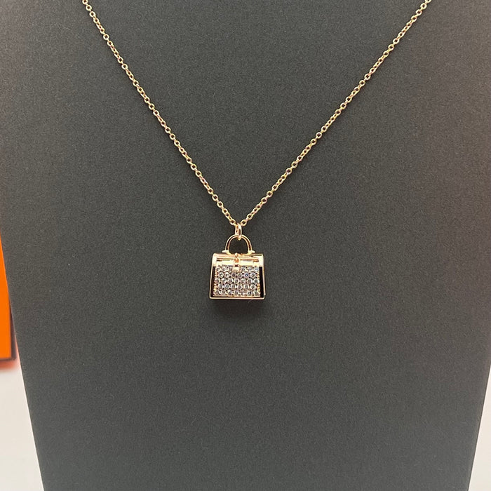 Hermès Amulettes Kelly Pendant Necklace  
 Color: Rose Gold/gold/silver