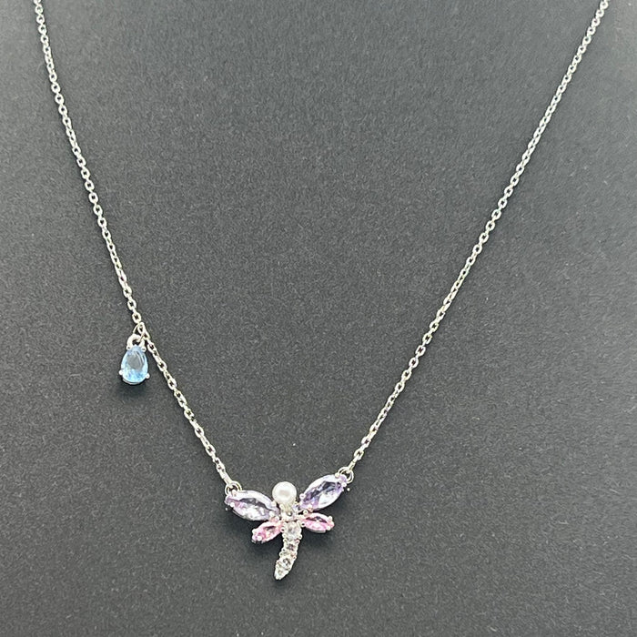 Mixed Cuts Dragonfly Y-Necklace / Pendant (Ariana Grande x Swarovski Collection)
 Color: Multicolored (Silver chain with pastel pink, purple, and a distinct blue crystal accent drop)
