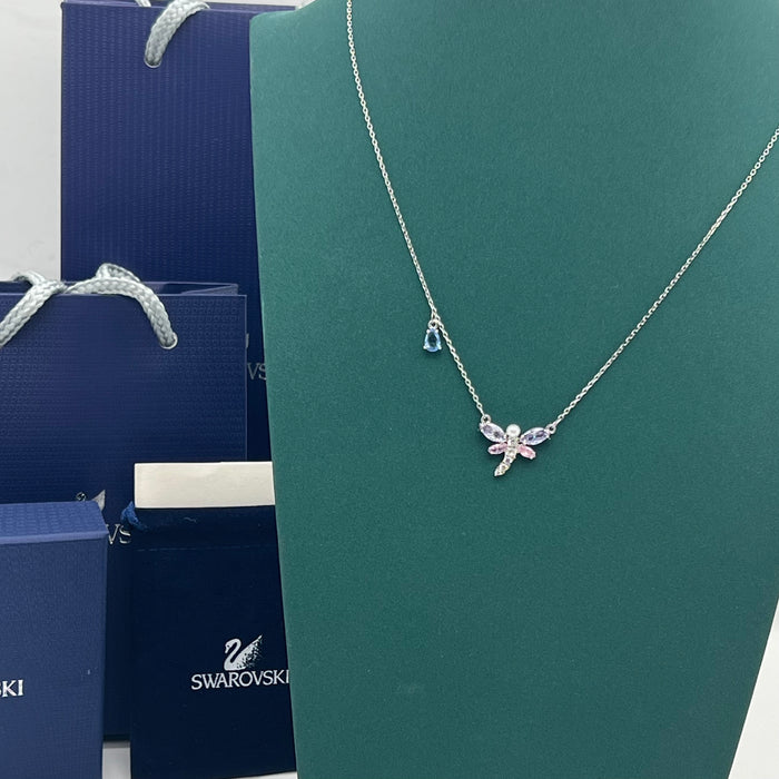 Mixed Cuts Dragonfly Y-Necklace / Pendant (Ariana Grande x Swarovski Collection)
 Color: Multicolored (Silver chain with pastel pink, purple, and a distinct blue crystal accent drop)